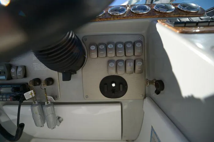 Slide: The Image of Control panel of a 2007 Formula 34 PC boat with switches and gauges. - 12