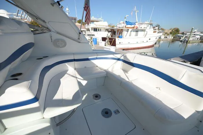 Slide: The Image of 2007 Formula 34 PC boat with spacious white seating area docked at a marina. - 18