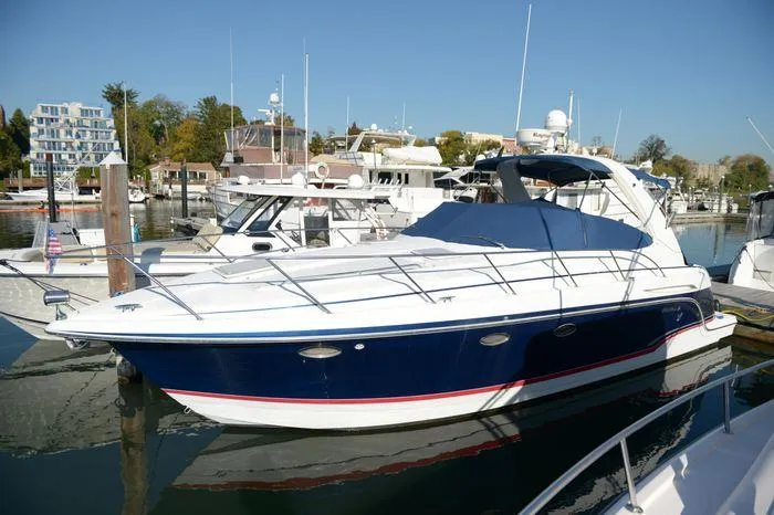 Slide: The Image of 2007 Formula 34 PC yacht docked in marina, featuring sleek design and blue hull. - 2