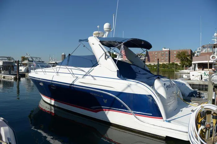 Slide: The Image of 2007 Formula 34 PC yacht docked at marina, featuring sleek blue and white design. - 3