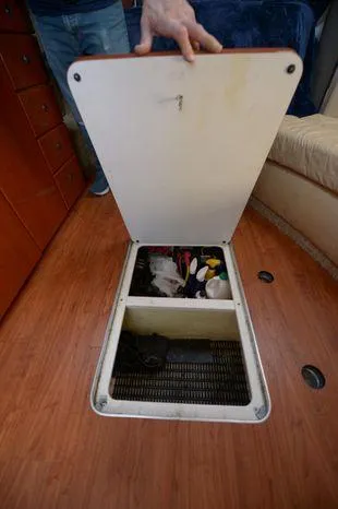 Slide: The Image of 2007 Formula 34 PC boat interior storage compartment with open hatch, revealing organized supplies. - 32