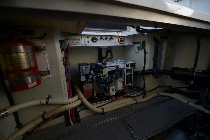 Slide: The Image of Engine room of a 2007 Formula 34 PC boat, featuring mechanical components and wiring. - 38