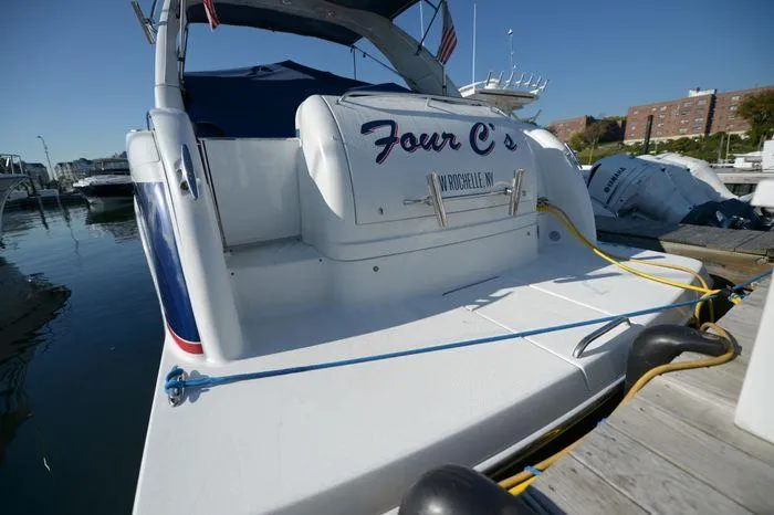 Slide: The Image of 2007 Formula 34 PC boat docked, rear view with "Four C's" name visible. - 4