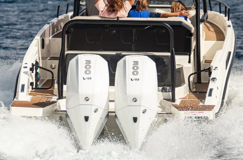Slide: The Image of 2025 Navan S30 boat with dual 300 V8 engines cruising on water. - 5