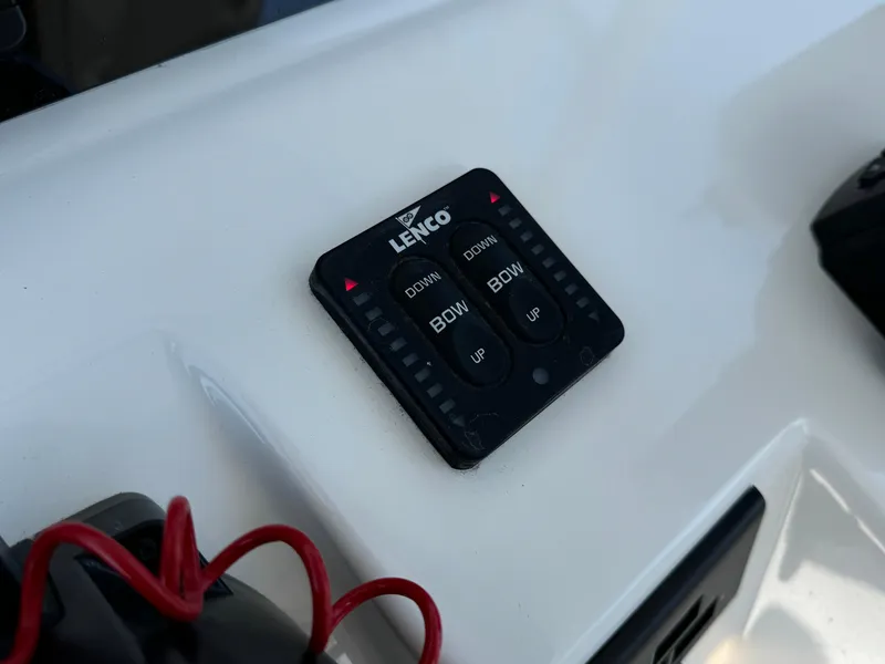 Slide: The Image of Lenco trim tab control on 2022 Edgewater 280CC boat dashboard. - 13