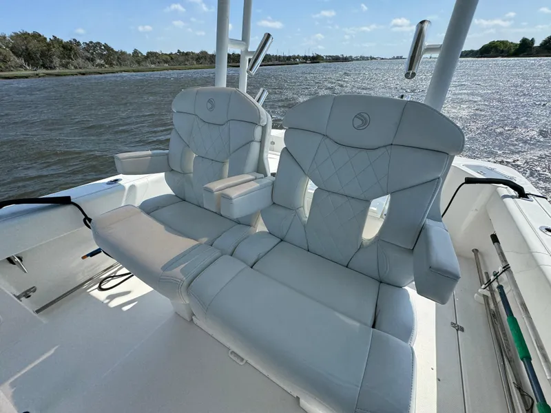 Slide: The Image of Edgewater 280CC 2022 boat with luxurious seating on a calm waterway. - 14