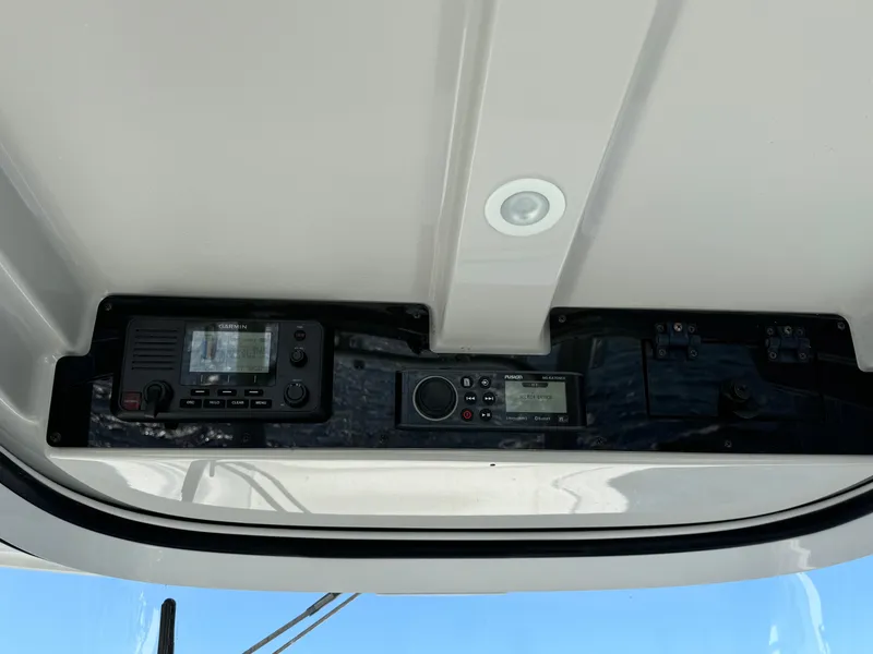 Slide: The Image of 2022 Edgewater 280CC boat dashboard with electronic controls and navigation equipment. - 17