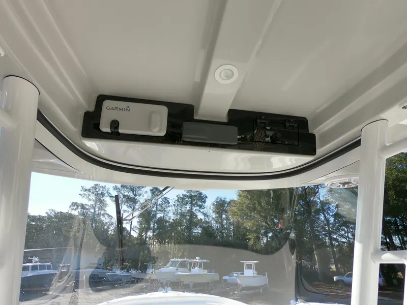 Slide: The Image of 2022 Edgewater 280CC boat interior with Garmin equipment and overhead console. - 18