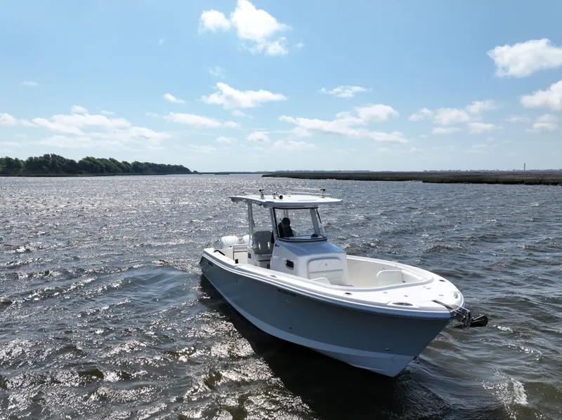 Slide: The Image of Edgewater 280CC 2022 boat cruising on a sunny day in open waters. - 2