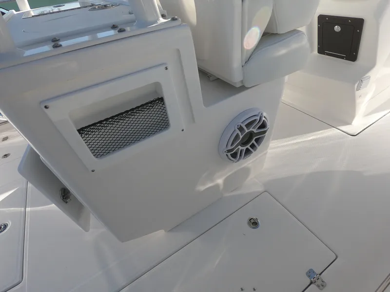 Slide: The Image of 2022 Edgewater 280CC boat interior with speaker and storage compartment. - 20