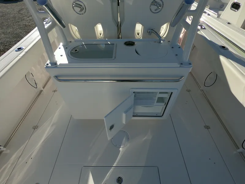 Slide: The Image of 2022 Edgewater 280CC boat interior with open storage compartment and sink. - 21
