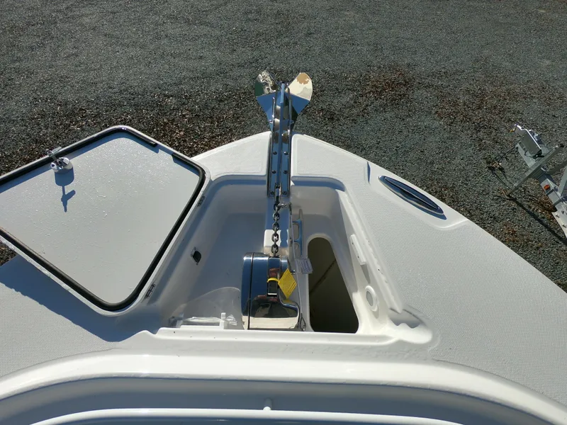Slide: The Image of 2022 Edgewater 280CC boat anchor compartment with open hatch, showcasing anchor chain mechanism. - 28