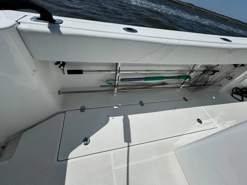 Slide: The Image of 2022 Edgewater 280CC boat deck with fishing gear storage. - 35