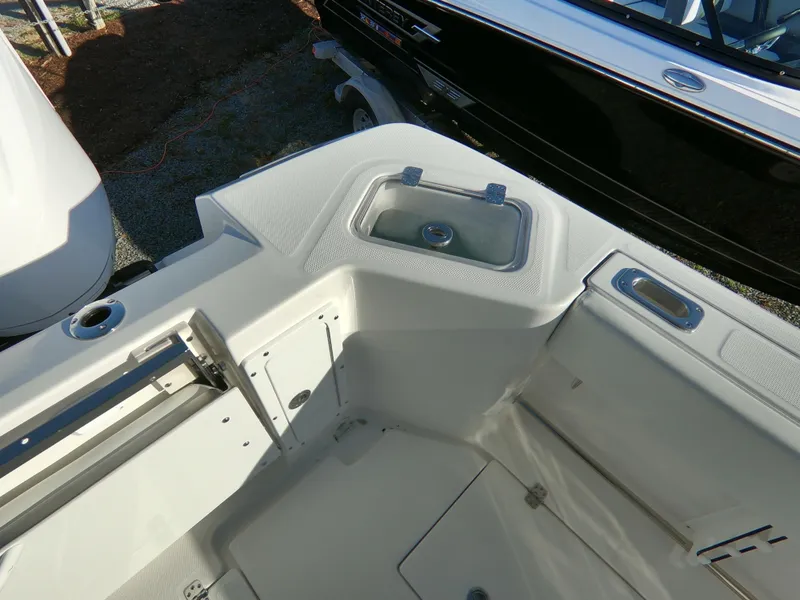 Slide: The Image of 2022 Edgewater 280CC boat interior with storage compartments and seating area. - 37