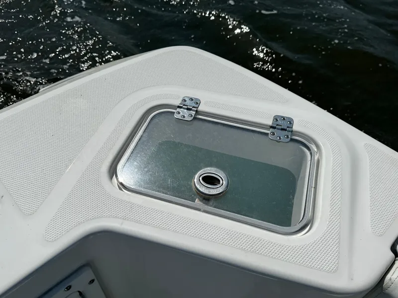 Slide: The Image of Edgewater 280CC 2022 boat deck with hatch, on water. - 38