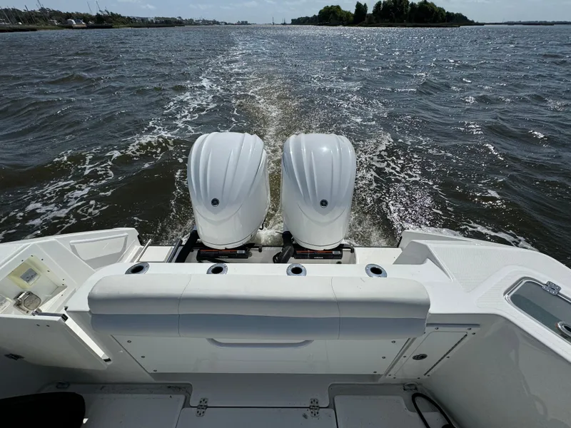 Slide: The Image of 2022 Edgewater 280CC boat with dual engines cruising on open water. - 39