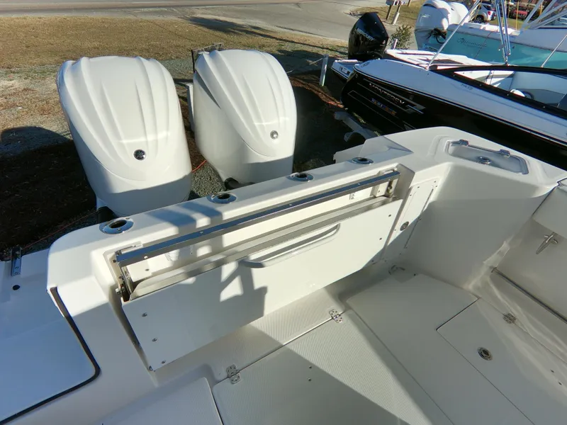 Slide: The Image of 2022 Edgewater 280CC boat with dual outboard engines and spacious deck layout. - 41