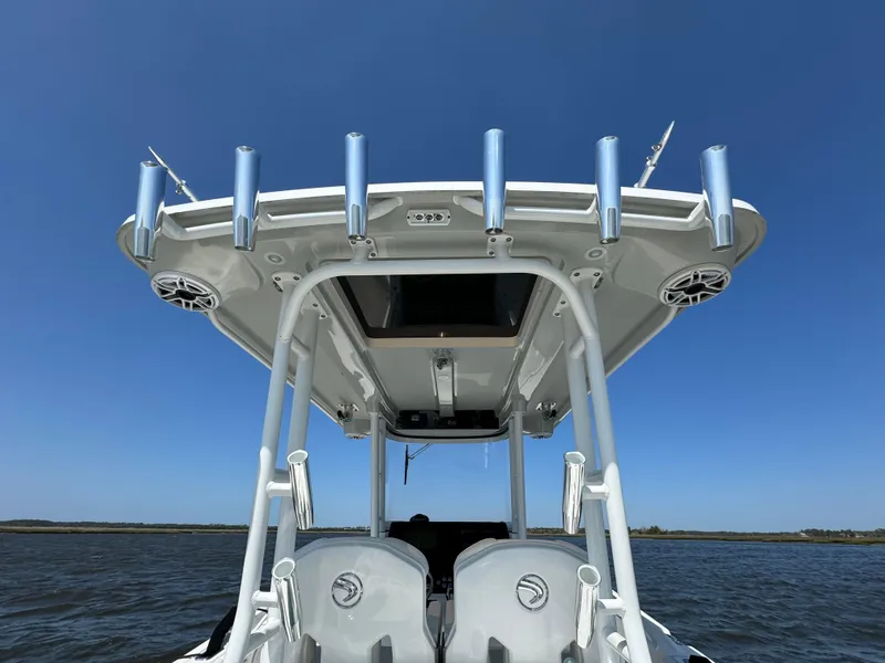 Slide: The Image of 2022 Edgewater 280CC boat with rod holders, viewed from the rear on a sunny day. - 43