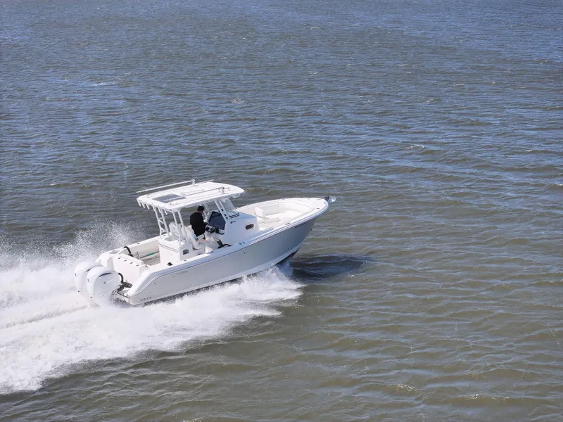 Slide: The Image of 2022 Edgewater 280CC boat cruising on open water, showcasing speed and performance. - 7