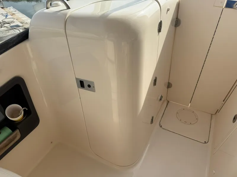 Slide: The Image of Interior view of 2015 Grady-White Freedom 255 boat, featuring storage compartments. - 11