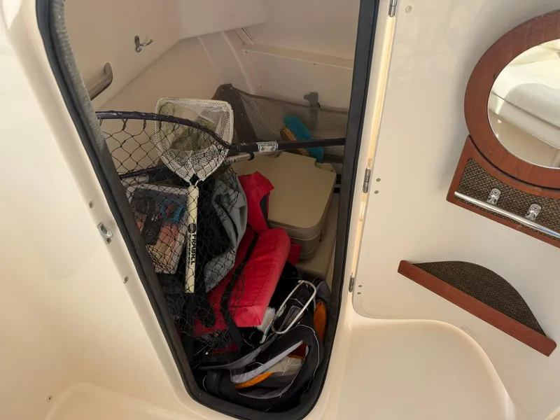 Slide: The Image of 2015 Grady-White Freedom 255 cabin with fishing gear and life jackets. - 12