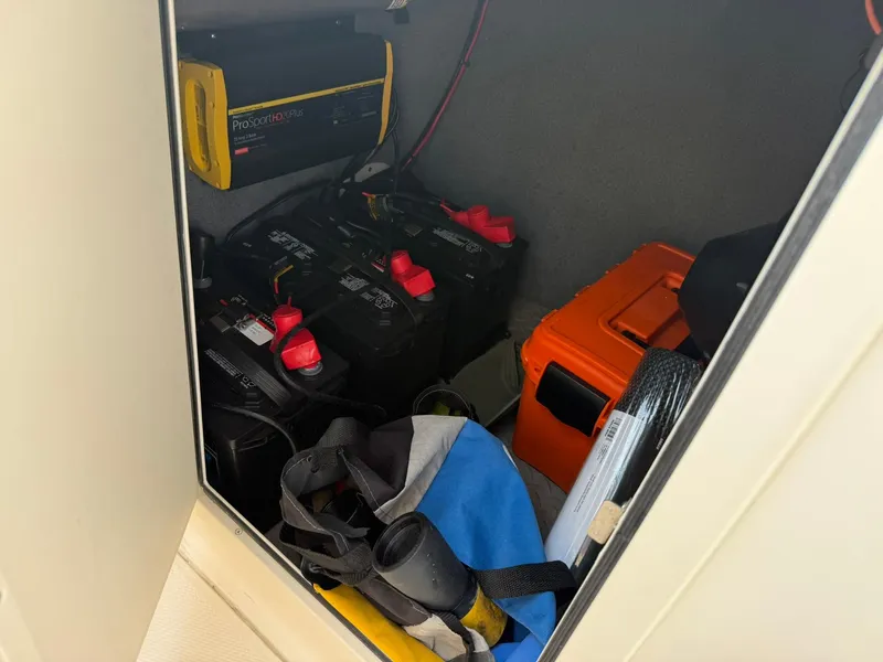 Slide: The Image of Storage compartment in a 2015 Grady-White Freedom 255 boat with batteries and equipment. - 13