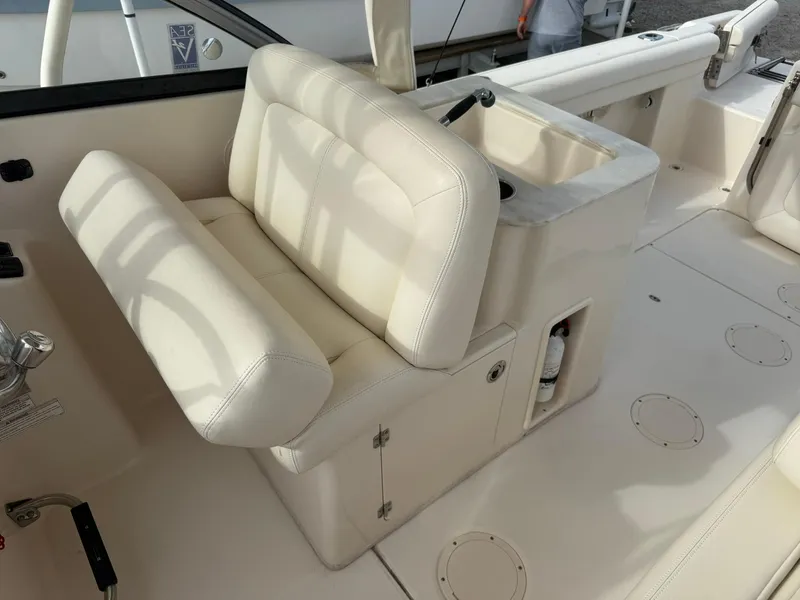 Slide: The Image of 2015 Grady-White Freedom 255 boat interior with white seating and control panel. - 14