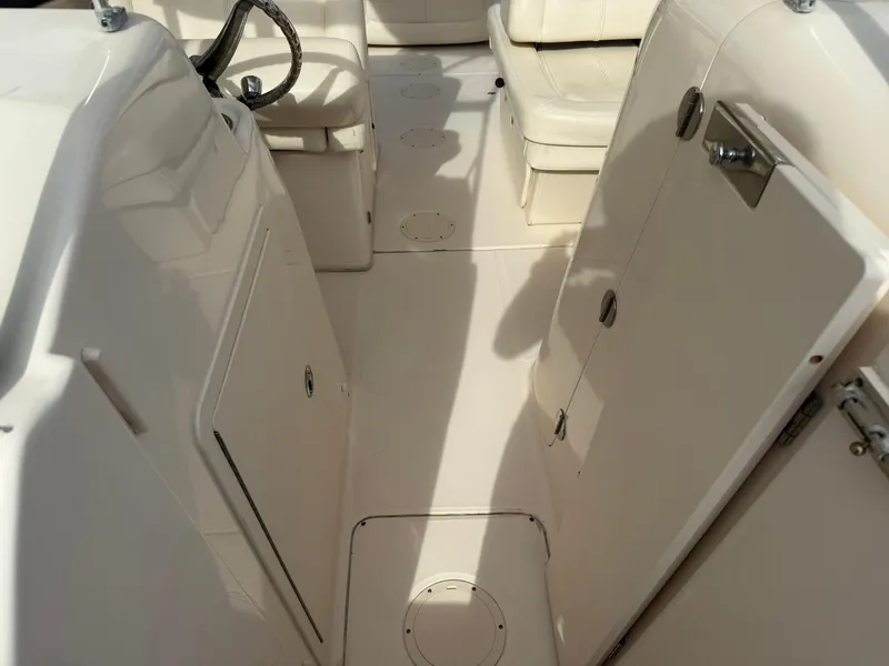 Slide: The Image of 2015 Grady-White Freedom 255 boat interior with seating and steering wheel. - 22