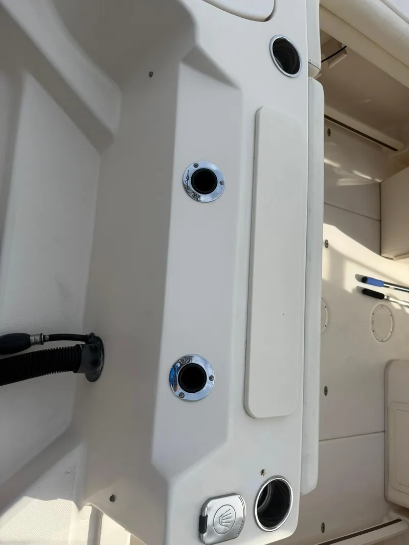 Slide: The Image of 2015 Grady-White Freedom 255 boat interior with rod holders and storage compartments. - 6