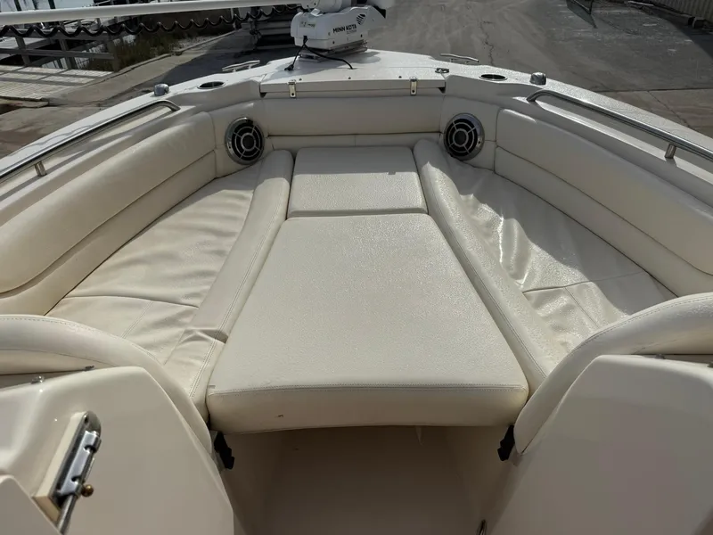 Slide: The Image of 2015 Grady-White Freedom 255 boat interior with cushioned seating and speakers. - 9