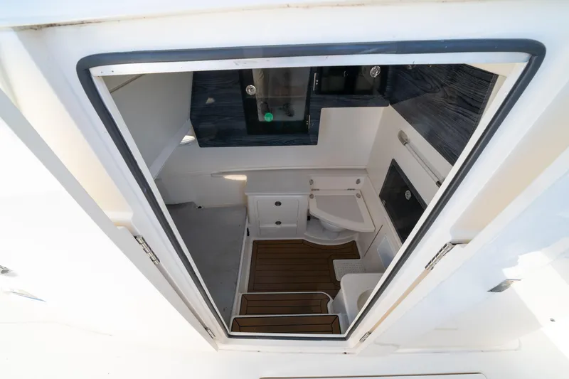 Slide: The Image of 2022 Cobia 350 Center Console cabin interior with modern amenities and wood flooring. - 10