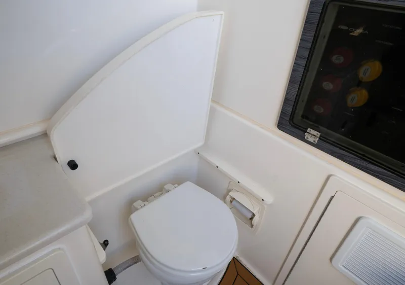 Slide: The Image of 2022 Cobia 350 Center Console boat interior with compact marine toilet. - 11