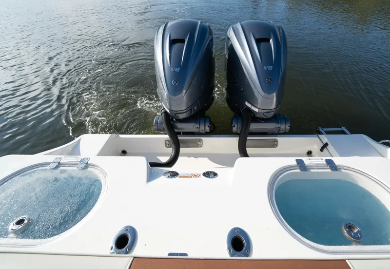 Slide: The Image of 2022 Cobia 350 Center Console with dual outboard engines on water. - 13