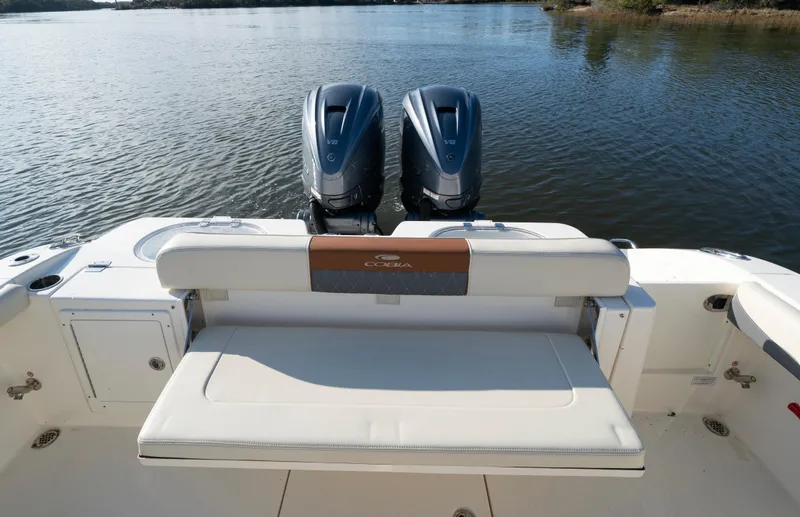 Slide: The Image of 2022 Cobia 350 Center Console boat with dual engines on a calm lake. - 14