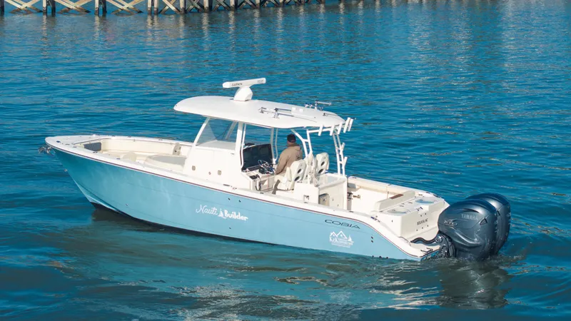 Slide: The Image of 2022 Cobia 350 Center Console boat on calm blue water. - 16