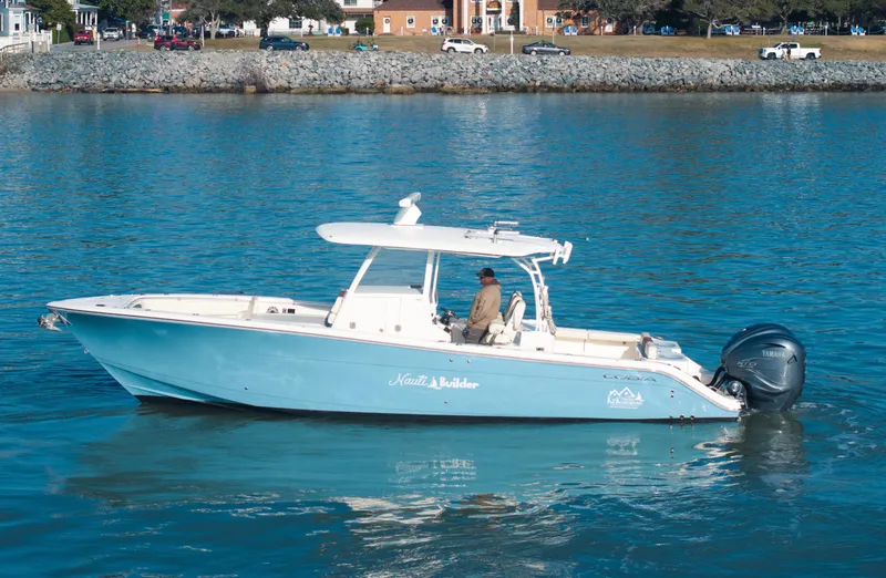 Slide: The Image of 2022 Cobia 350 Center Console boat on calm water, side view. - 17