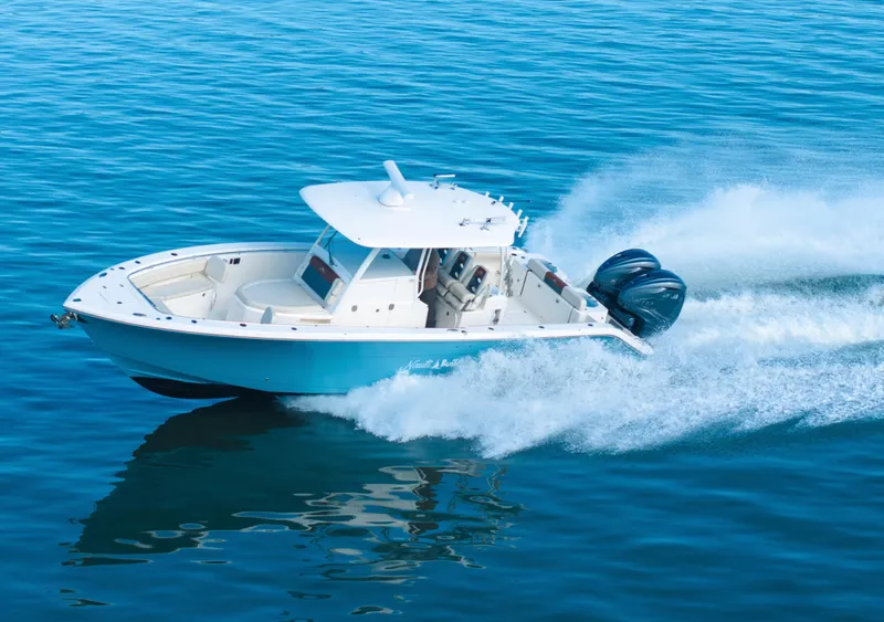 Slide: The Image of 2022 Cobia 350 Center Console boat cruising on open water. - 18