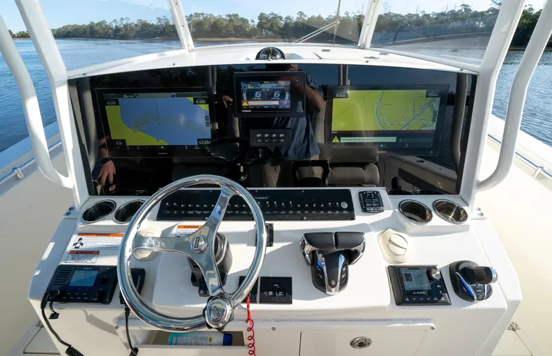 Slide: The Image of 2022 Cobia 350 Center Console dashboard with navigation screens and steering wheel. - 3