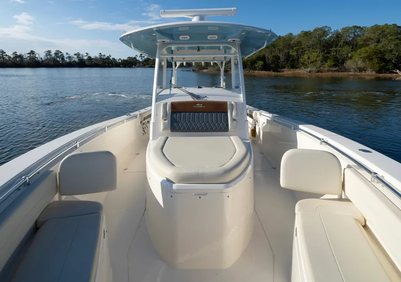 Slide: The Image of 2022 Cobia 350 Center Console boat on calm water, featuring spacious seating and sleek design. - 6