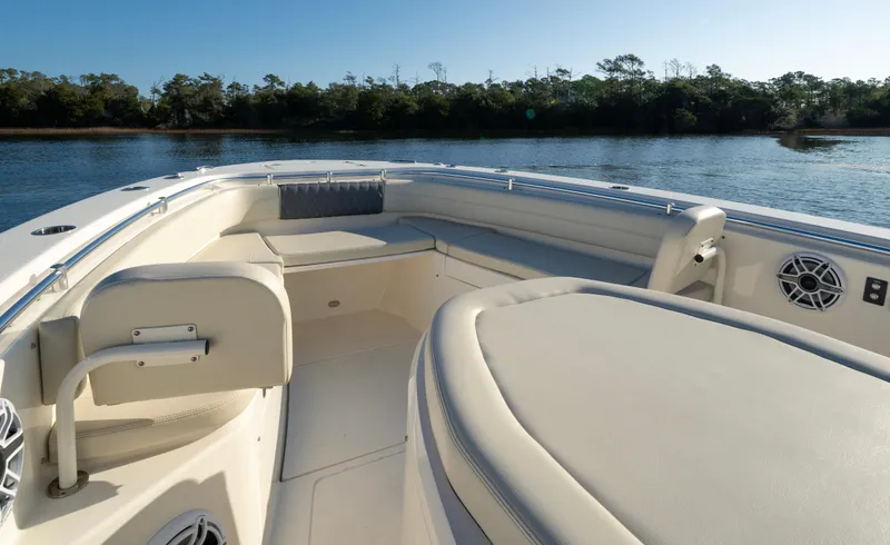 Slide: The Image of 2022 Cobia 350 Center Console boat interior with seating, on calm water. - 8