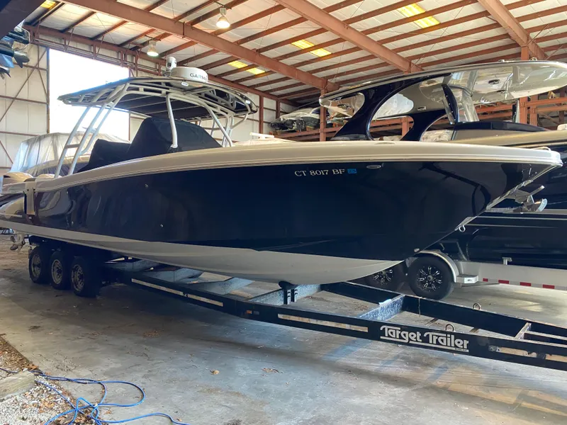 The Image of 2016 Chris-Craft Catalina 34 boat on trailer in warehouse setting. - 0