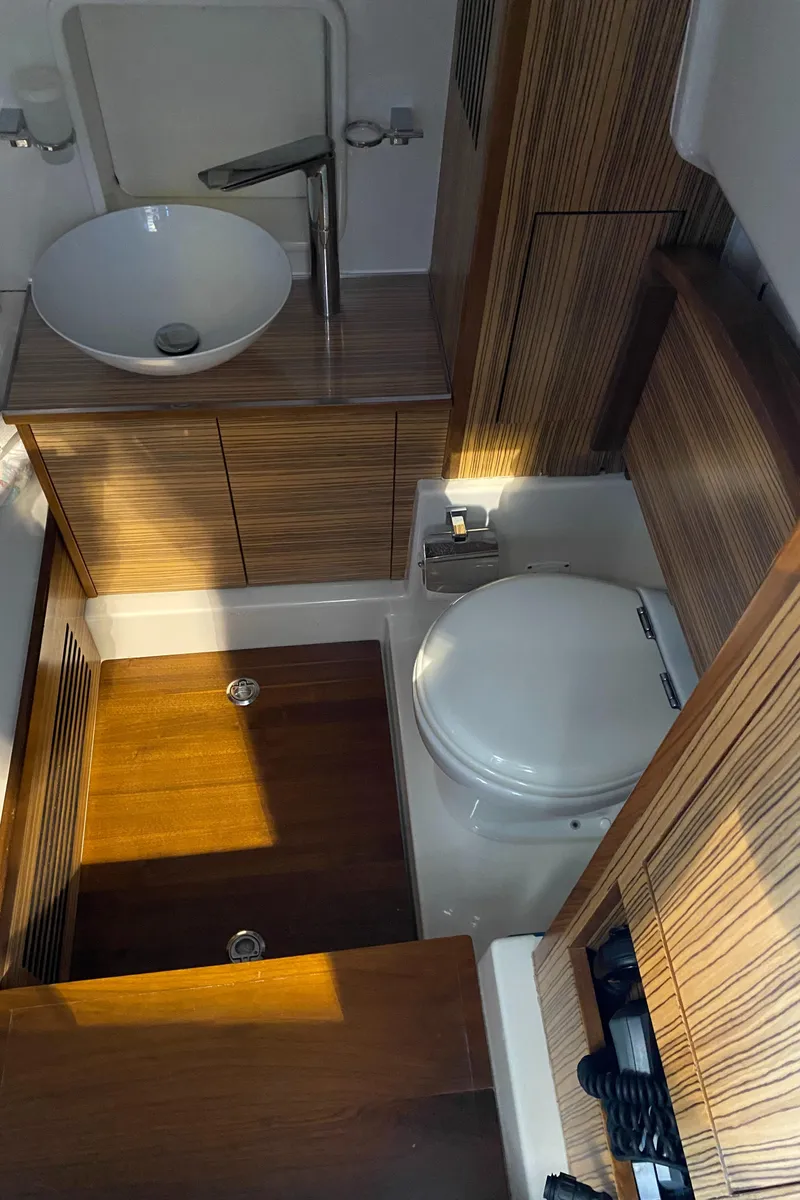 Slide: The Image of 2016 Chris-Craft Catalina 34 bathroom with modern sink and wooden cabinetry. - 15
