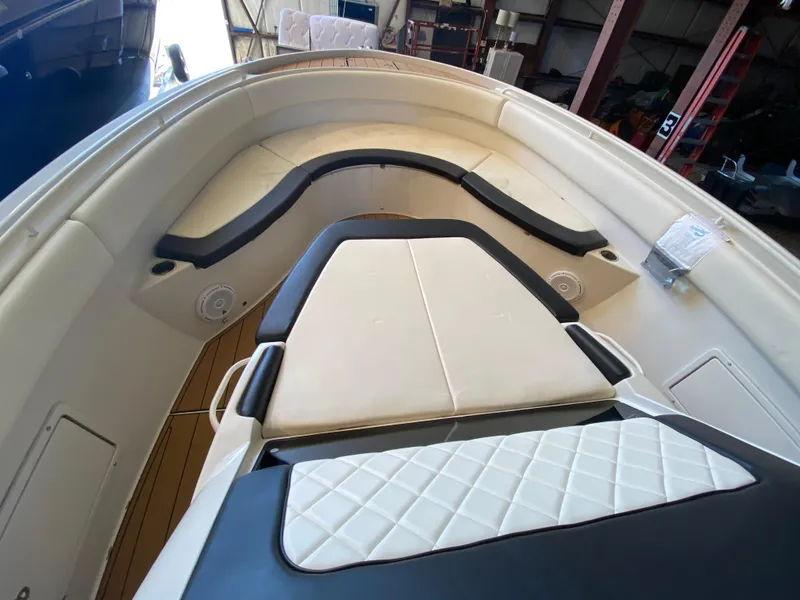 Slide: The Image of 2016 Chris-Craft Catalina 34 boat interior with cushioned seating and wood flooring. - 16