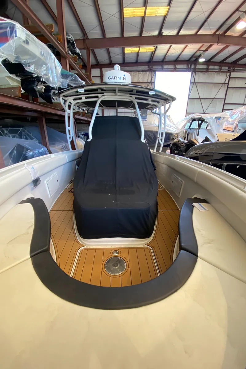 Slide: The Image of 2016 Chris-Craft Catalina 34 boat in storage, featuring teak deck and covered seating. - 17