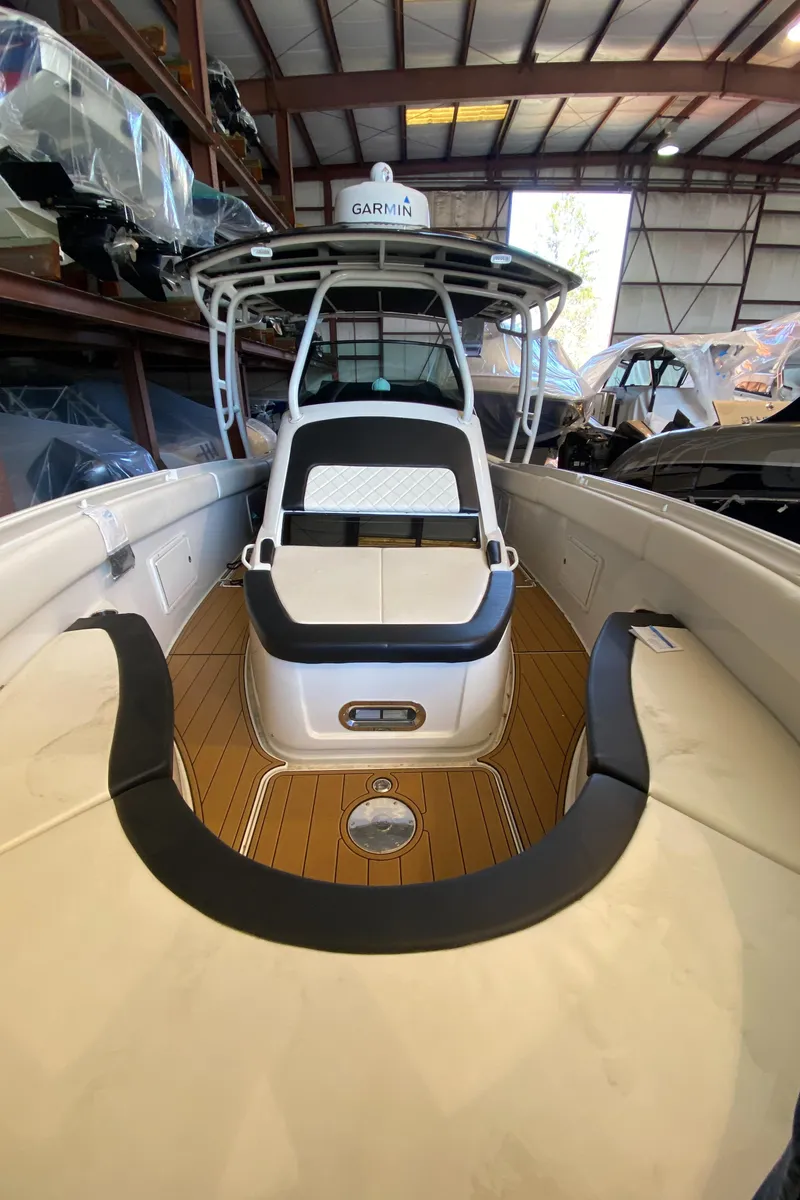 Slide: The Image of 2016 Chris-Craft Catalina 34 boat in storage, featuring sleek design and spacious deck. - 18