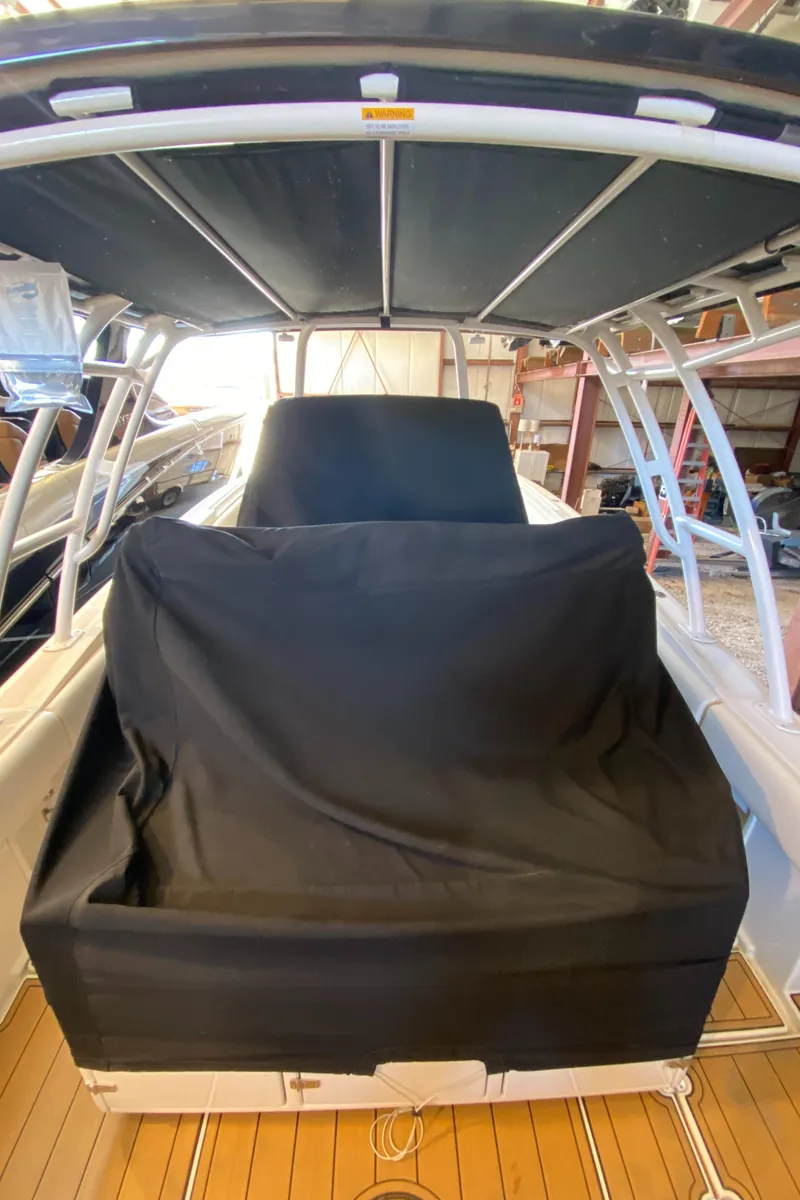 Slide: The Image of 2016 Chris-Craft Catalina 34 boat with covered seating, docked indoors. - 4