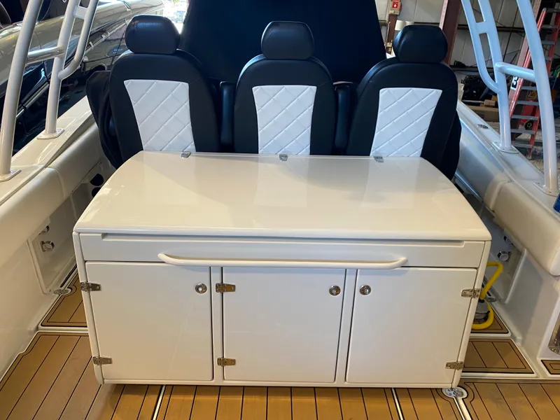 Slide: The Image of 2016 Chris-Craft Catalina 34 interior with seating and storage cabinet. - 5