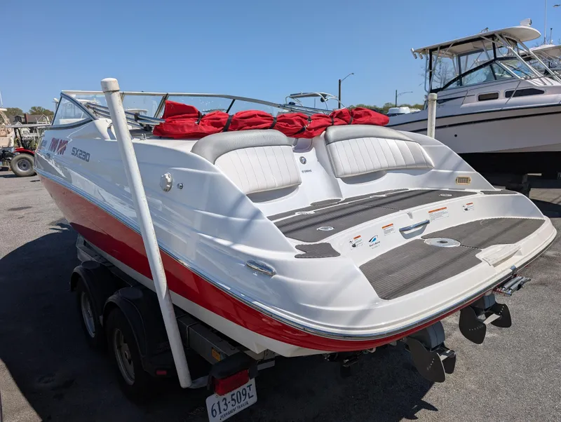 Slide: The Image of 2008 Yamaha Boats SX230 HO, white and red, on trailer, docked at marina. - 3