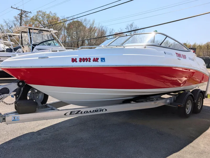 Slide: The Image of 2008 Yamaha Boats SX230 HO on trailer, red and white design, parked outdoors. - 4