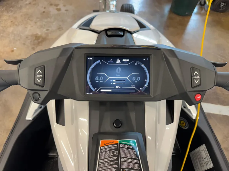 Slide: The Image of 2024 Taiga Orca dashboard with digital display and control buttons in a workshop setting. - 11